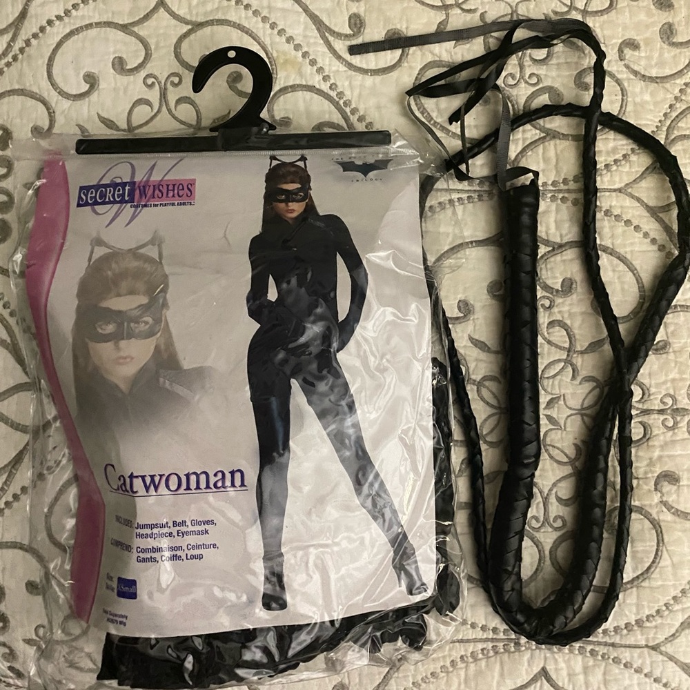 This is a like new, cat woman costume with a separate black whip accessory.